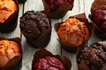 Mix of muffins ( cupcake ) chocolate , vanilla , berries . Top view