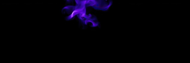 Fototapeta premium Purple flame burning bright on a black background with a mesmerizing glow, hot, powerful, dark