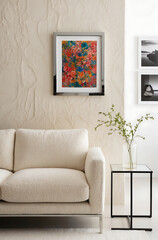Minimalist, japandi style interior design of modern living room. Close up of stylish boucle sofa near stucco wall with colored art frame