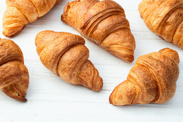 Group of sweet croissant . French morning breakfast . Top view