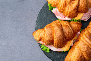 Croissant sandwich with salad ham and cheese . Top view