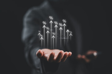 Businesswoman showing percentage icons and up arrow icons with graph indicators. Concept of financial interest rates and mortgage rates. Interest Rates Stocks Finance Ratings Mortgage Rates.