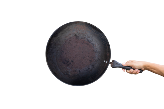 Hand holds a round rusty cast iron pan isolated on white background. Do not use old rusty pans. Because it can cause health problems. 