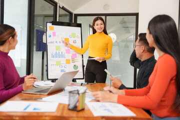 Group of Asian businessmen are sitting in a meeting, talking, exchanging knowledge. Presentation about office work