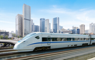 Fototapeta premium High-speed rail speeds on Bridges and the modern city skyline of chongqing, China