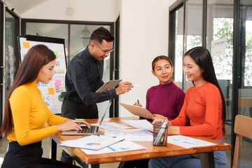 Group of Asian businessmen are sitting in a meeting, talking, exchanging knowledge. Presentation about office work