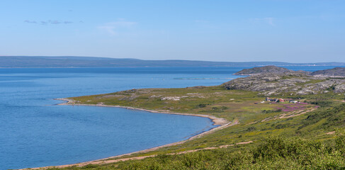 The desert stony shore of the small gulf of Barents sea. Short polar summer in Finnmark, Norway
