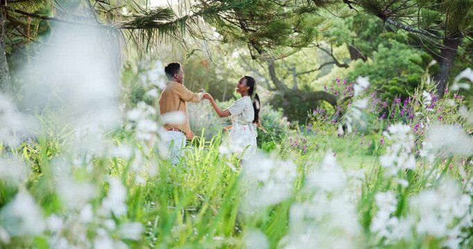 Black couple, forest and dancing with love in spring for bonding, holiday or romance in nature. Young African, man and woman enjoying time together in flower garden or woods for happy relationship