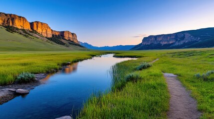 Mountain Riverbank Serenity: Majestic Peaks Meet Reflective Waters.