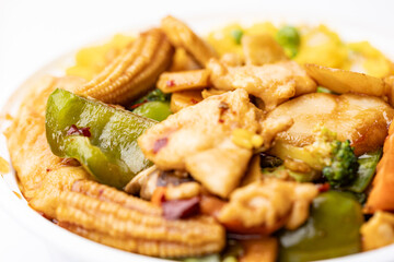 Szechuan chicken dish cooked for takeout in Chinese restaurant close up