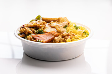 Chinese restaurant lunch special to-go: chicken with broccoli and fried rice in a plastic container.