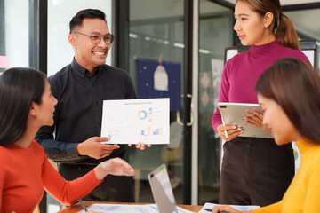 Group of Asian businessmen are sitting in a meeting, talking, exchanging knowledge. Presentation about office work