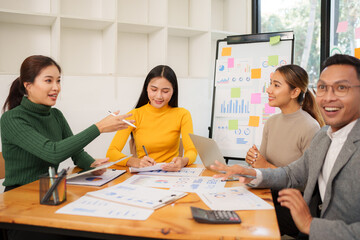 Group of Asian businessmen are sitting in a meeting, talking, exchanging knowledge. Presentation about office work