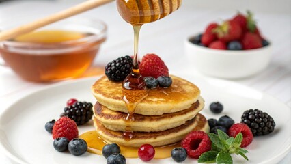 A delicious stack of pancakes topped with fresh berries and drizzled with honey, creating a mouthwatering breakfast scene. The combination of blueberries, raspberries, and blackberries adds a colorful