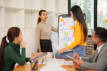 Group of Asian businessmen are sitting in a meeting, talking, exchanging knowledge. Presentation about office work