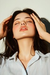 Naklejka premium Thai Woman Enjoying Luxurious Skincare Routine with Peaceful Expression