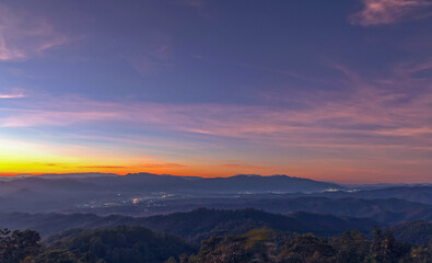 Sunset sky with mountains, Predawn clear sky with orange horizon and blue atmosphere. Smooth orange blue gradient of dawn sky.