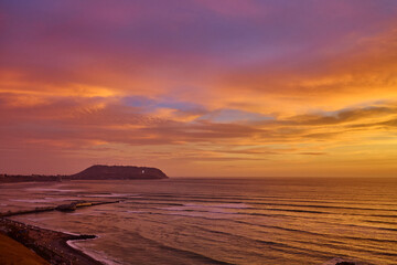 Fototapeta premium Breathtaking sunset views over La Costa Verde From Miraflores, it’s pure magic watching the cliffs meet the Pacific, waves crashing below, and endless skies above. 
