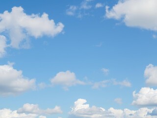 Beautiful fluffy clouds in a bright blue sky, creating a serene and calming atmosphere, serene, atmosphere