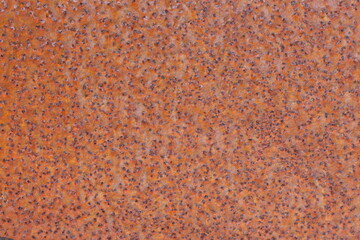 A close up photograph of rusted metal sheeting, background texture