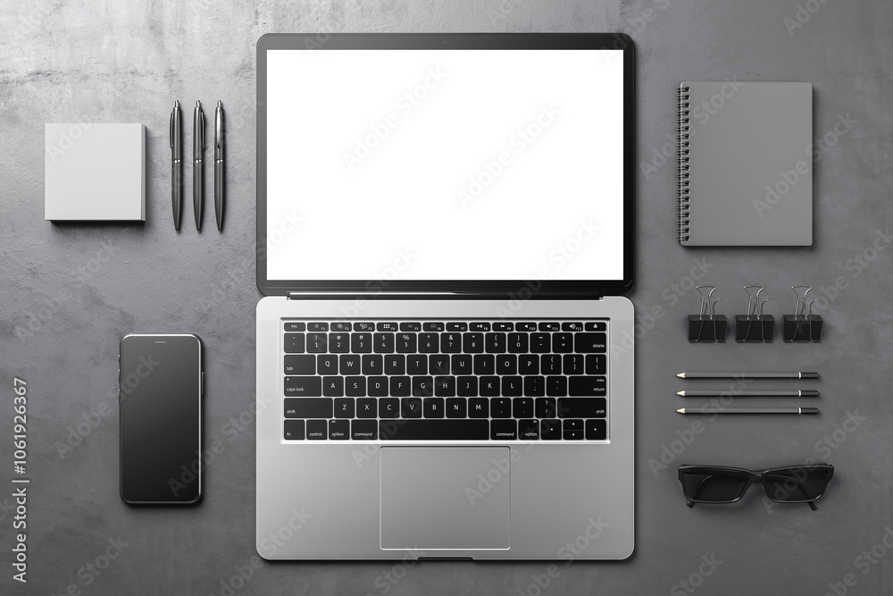 Poster top view on blank white monitor screen of fully open modern laptop with black keyboard on dark grey 
