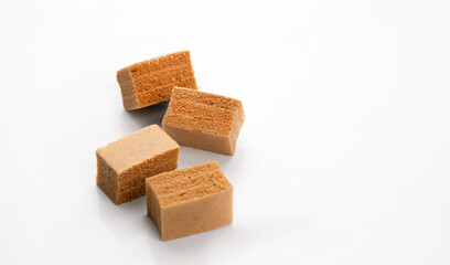 Cubes of apple marshmallow lie on a light background