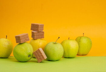 Green apples on yellow and green background