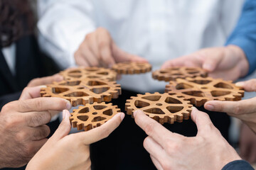 Business team joining cogwheel in circular together symbolize successful group of business...