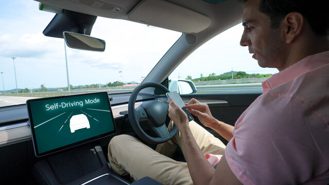 Self driving car or autonomous vehicle travel on speed highway with driverless system and autopilot mode allowing man driver relax and focus on smartphone without compromising safety. Perpetual