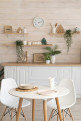 bright kitchen with wooden countertop and table in the middle of the room