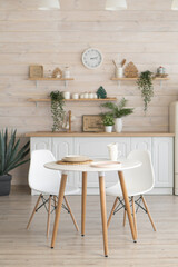 bright kitchen with wooden countertop and table in the middle of the room