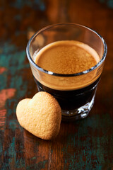 Coffee in glass cup on dark background. Close up. Copy space.	