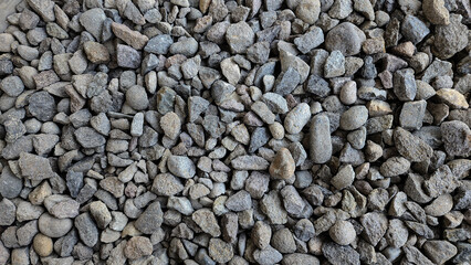 Pile of rubble top view. Top view of gravel or stone. Backdrop of the gray gravel cobblestones. Stone background. Extreme closeup