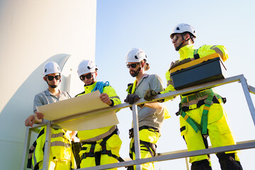 Team of electrical engineer is perform the inspection and maintenance of electric generating windmill turbine.