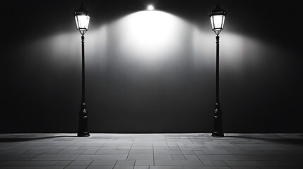 Two street lamps illuminate a blank wall at night.