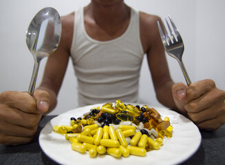 an assortment of different sized pills, vitamins, and supplements on a plate.
