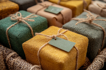 Detailed view of eco-conscious gift options with Green Monday sale tags, featuring packaging made of kraft paper and natural twine. The colorful arrangement emphasizes a sustainable approach