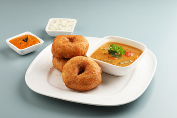 Traditional breakfast of South India IDLY VADA served with sambar Chutney in a ceramic plate