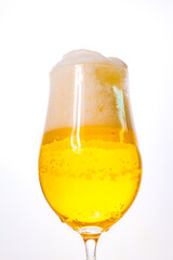 A bubbles in a glass of foamy beer on a white background. cooling drink. 