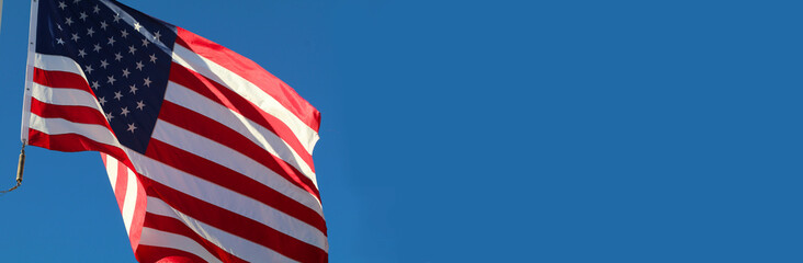 Waving Flag of USA on blue sky background