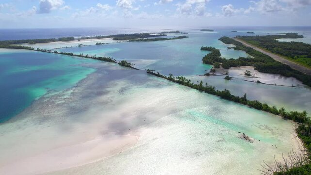 An ascending aerial shot of Palmyra Atoll lagoon, islands and causeways