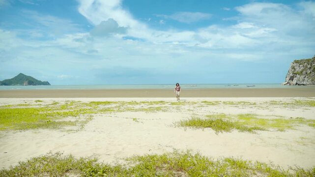 hippie rastaman dreads locks man run from the beach on a sunny day blue skies 