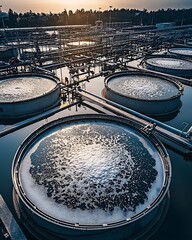 Industrial Wastewater Treatment Plant with Circular Aeration Tanks and Evening Light Reflection : Generative AI