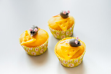 Whimsical Cupcakes Decorated with Cute Gary Mice and Yellow Cheese for a Kids Party. These charming treats are perfect for a children's party, adding a fun and playful touch to any celebration.