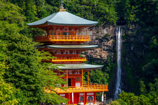Red pagoda of Seigantoji Buddhist Temple and Nachi no Taki waterfall, Nachikatsuura, Wakayama, Japan. This waterfall is part of the Sacred Sites and Pilgrimage Routes in the Kii Mountain Range