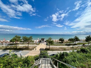 Magnificent view of the Bay of Lübeck in Scharbeutz (Baltic Sea) with blue sky, promenade, beach and blue sea. © Christian