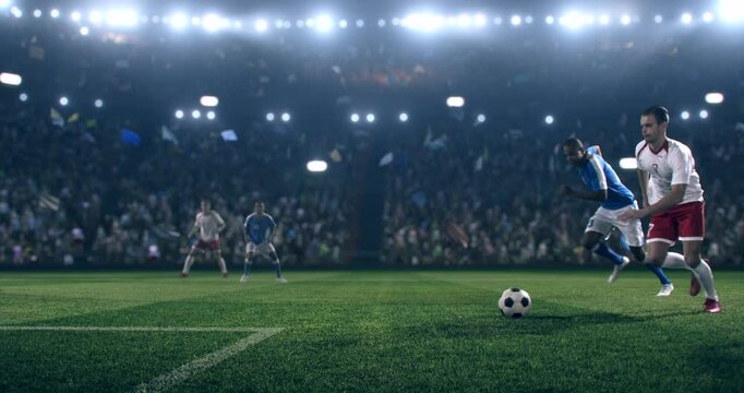 Football player is dribbling the ball down the field and kicks the ball towards the goal while other players trying to interfere. Professional stadium with animated crowd.