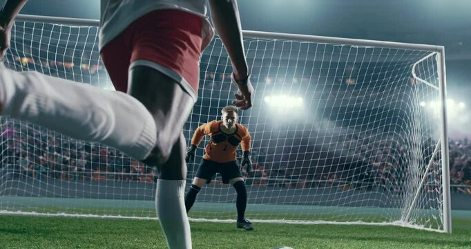 Soccer forward scores a goal. Goalie jumps and fails to catch a ball. Professional soccer stadium with crowd.
