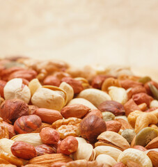 Variety of nuts and seeds closeup with selective focus - peeled walnut, hazelnuts, peeled peanut,...