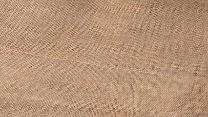 Hessian sackcloth woven fabric texture background in beige cream brown color.  Cloth texture background. Copy space. High quality photo